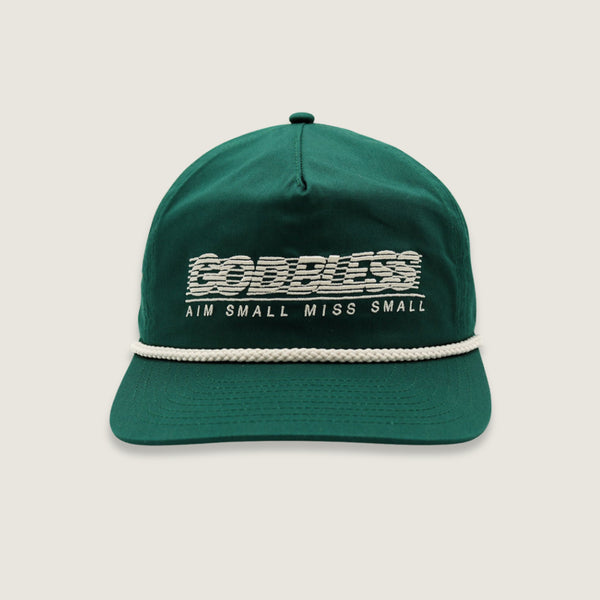 A dark green baseball cap with a white rope detail across the brim and white embroidered text reading 'GODLESS' and 'AIM SMALL MISS SMALL' on the front, shown against a light beige background.